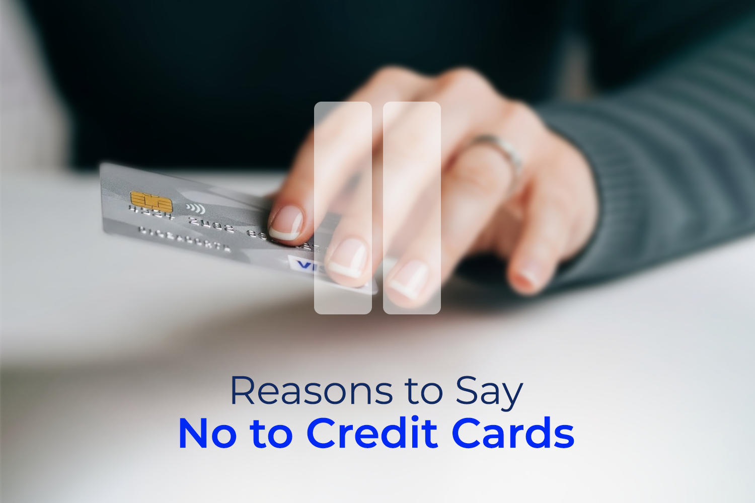 A hand holding a credit card while there's a pause icon on the screen from 7 Reasons to say no to credit cards on money fellows